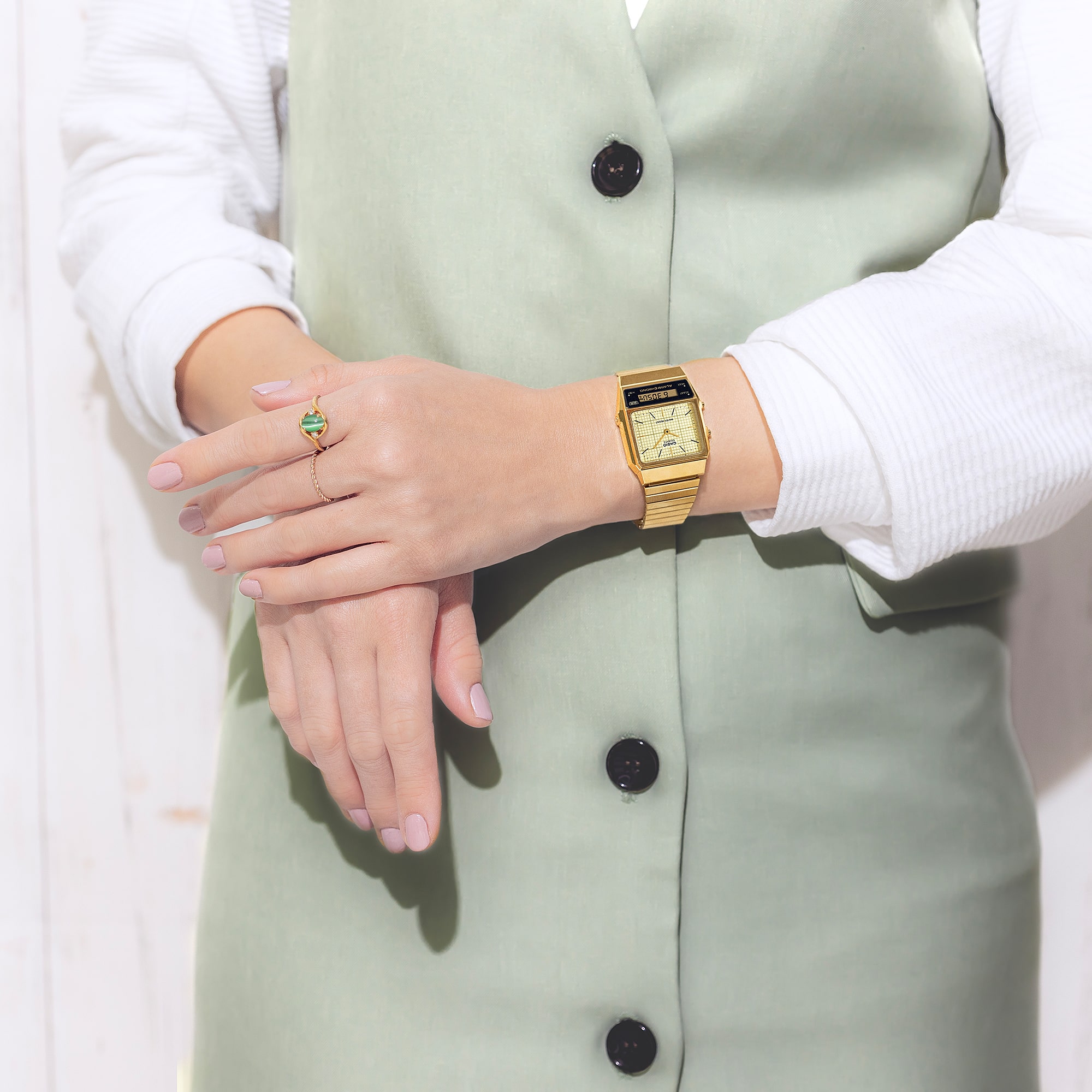 Die Casio Vintage Analoguhr "AQ-800EG-9A" mit goldfarbigem Armband und hellem Zifferblatt. Die Zeiger sind gold, unterhalb der Lünette ist eine digitale Datumsanzeige.