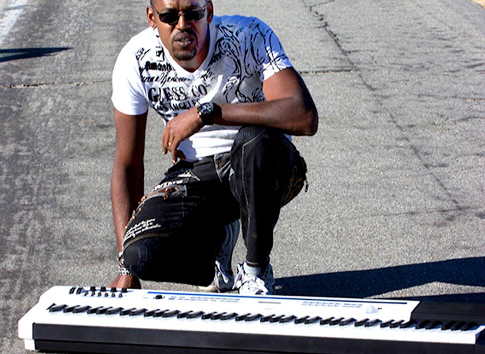 Stephan Dereine kneeling behind a Privia PX-5S digital piano