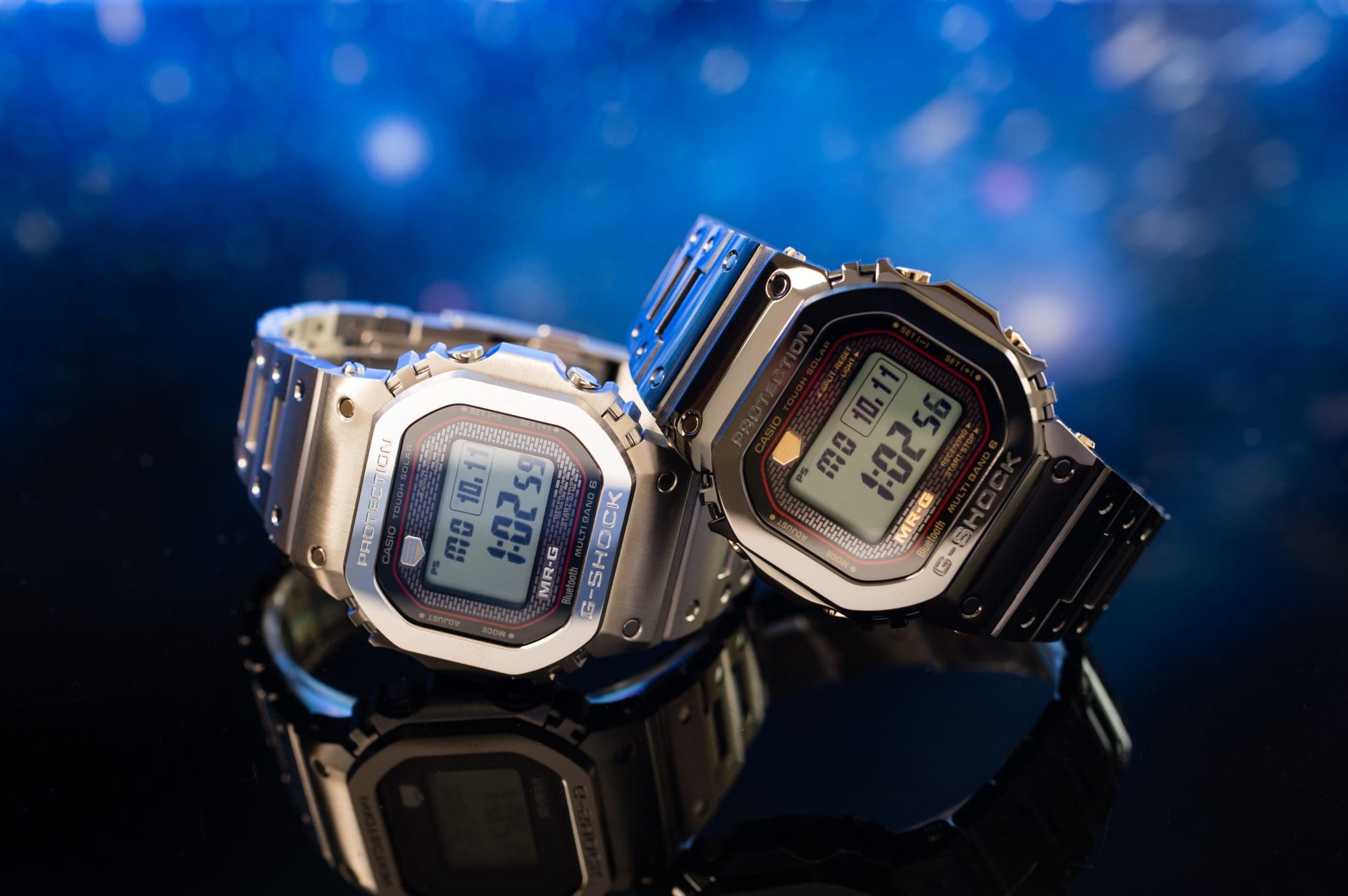 Two CASIO titanium watches laying side by side.