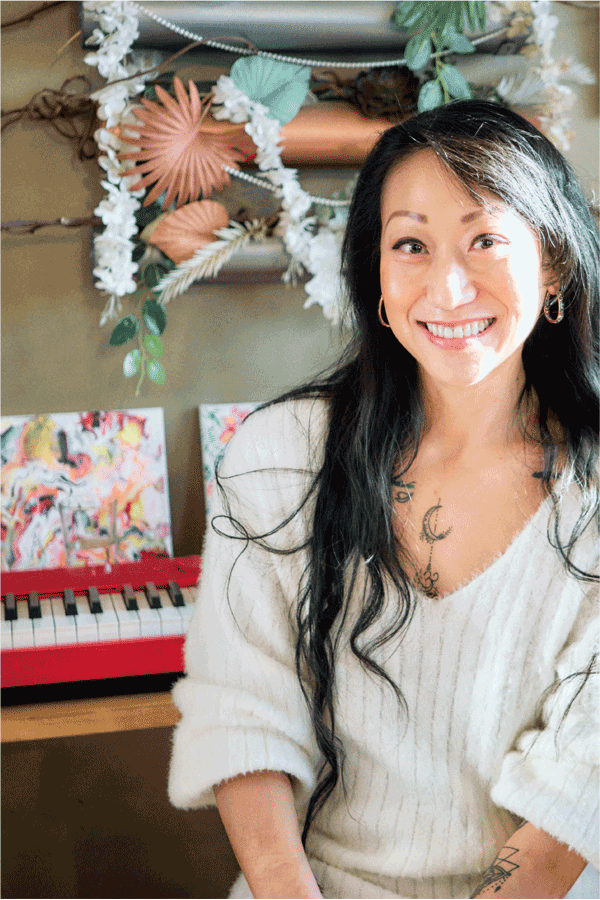 La chef Asie Mei, de South Boston, delante de su piano digital Privia rojo. La imagen enlaza con su página «Life with Privia».