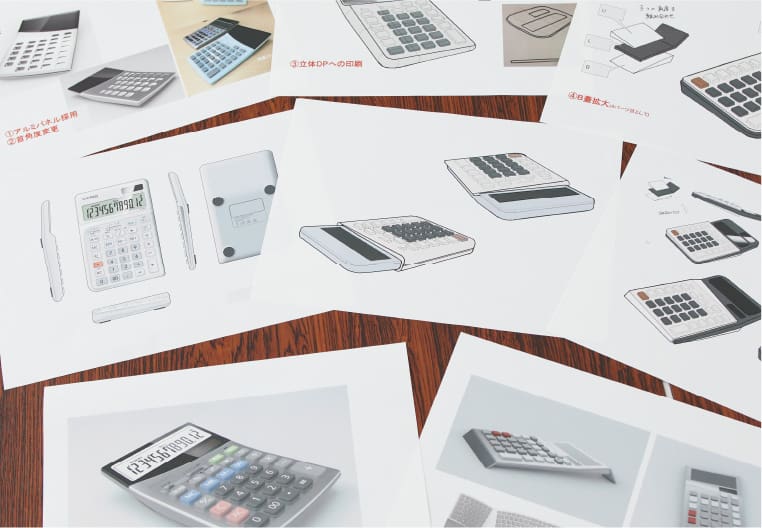 Different calculator designs on paper next to each other