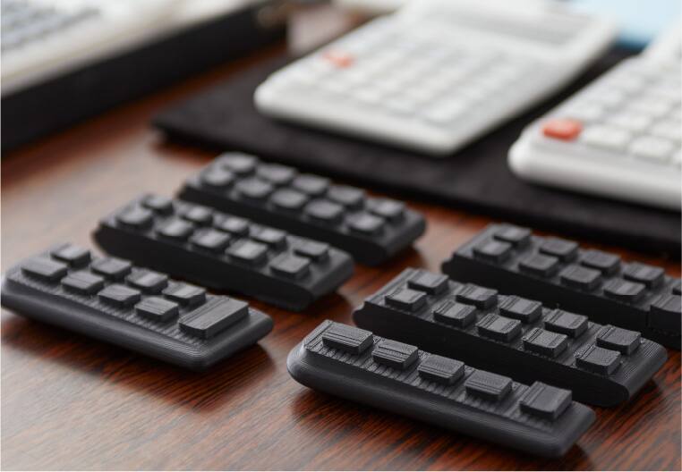 Parts of the ergonomic calculator keyboard side by side