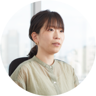 Portrait of developer Kanako Kumira with brown hair, fringes and a light green blouse