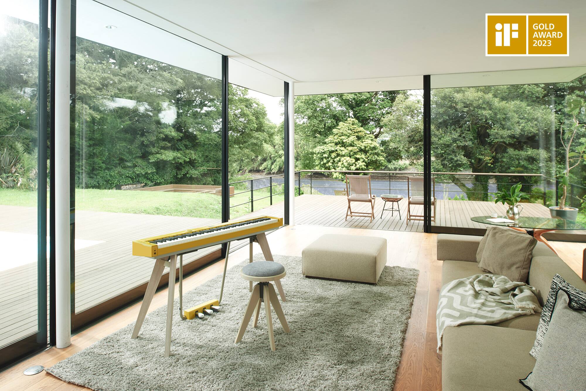 The Privia PX-S7000HM stands in a modern furnished living room. In the right corner of the image is the iF DESIGN AWARDS 2023 Gold logo.