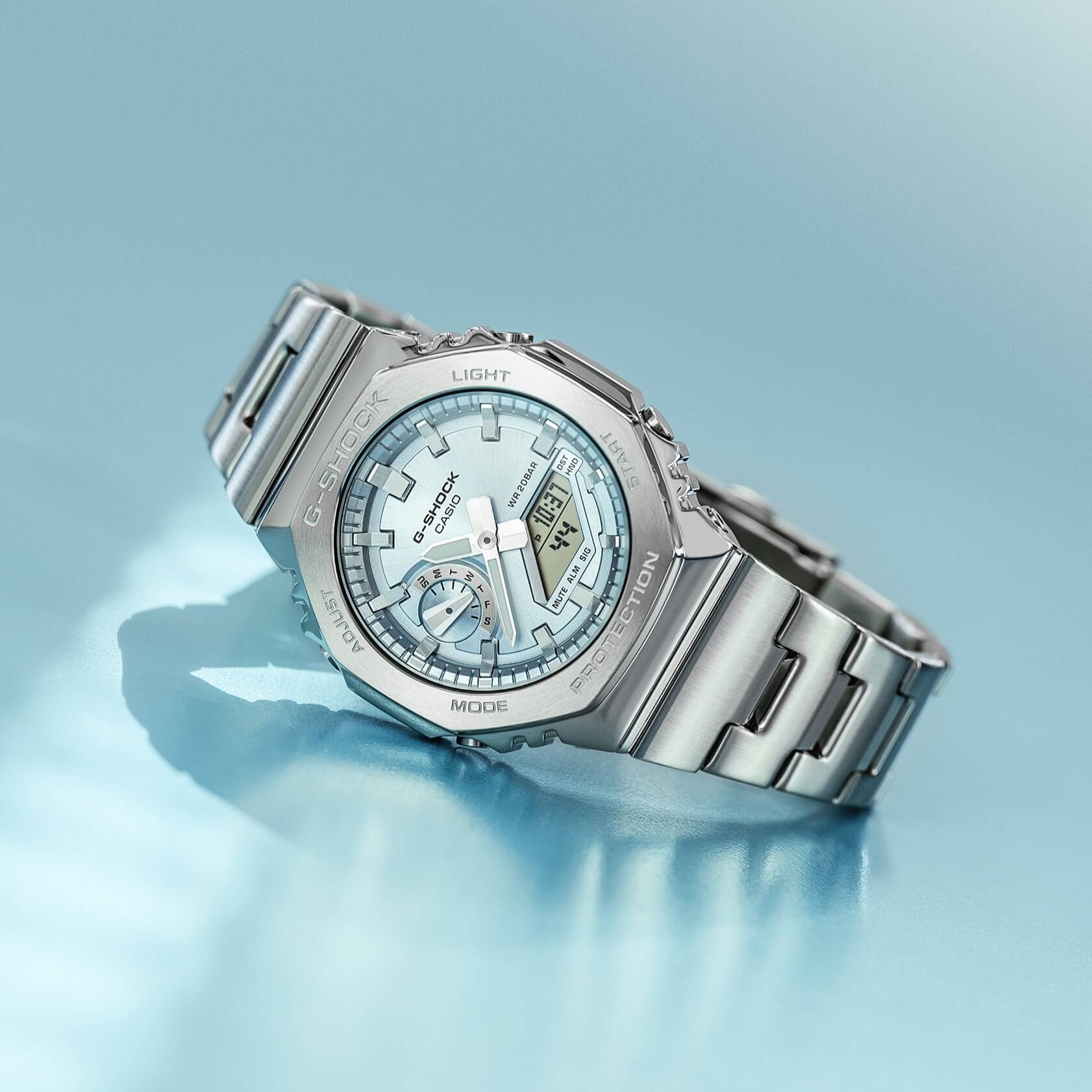 The GM-2110D-2BER with light blue dial is set against a light blue background.
