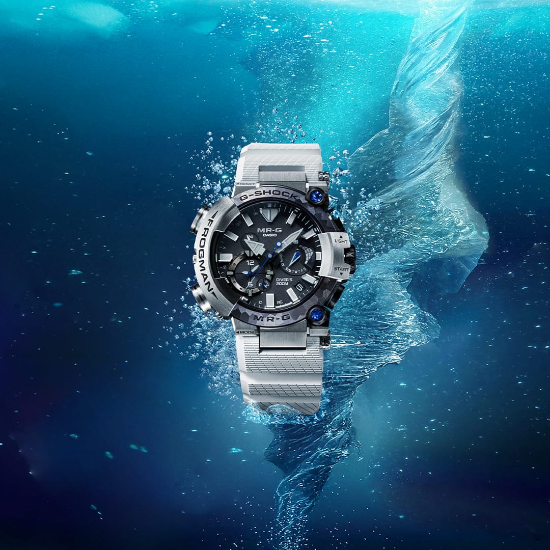 The silver-coloured G-SHOCK Frogman MRG-BF1000EB underwater in a brinicle vortex