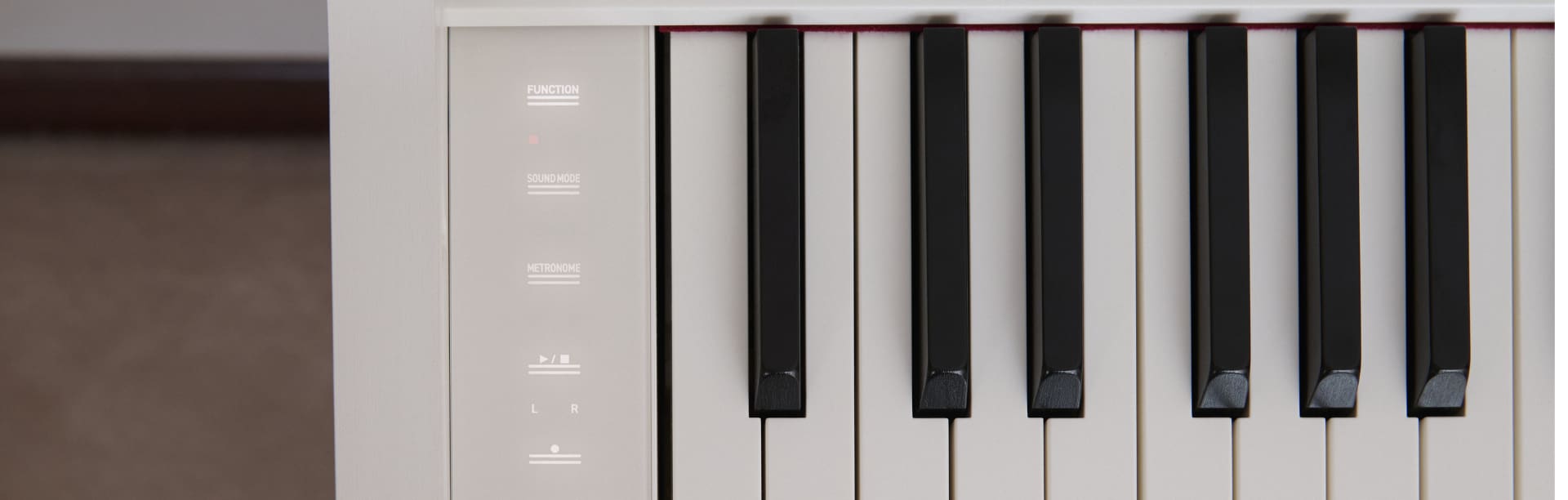 A close up of the piano keys on the white AP-S200WE with product link.