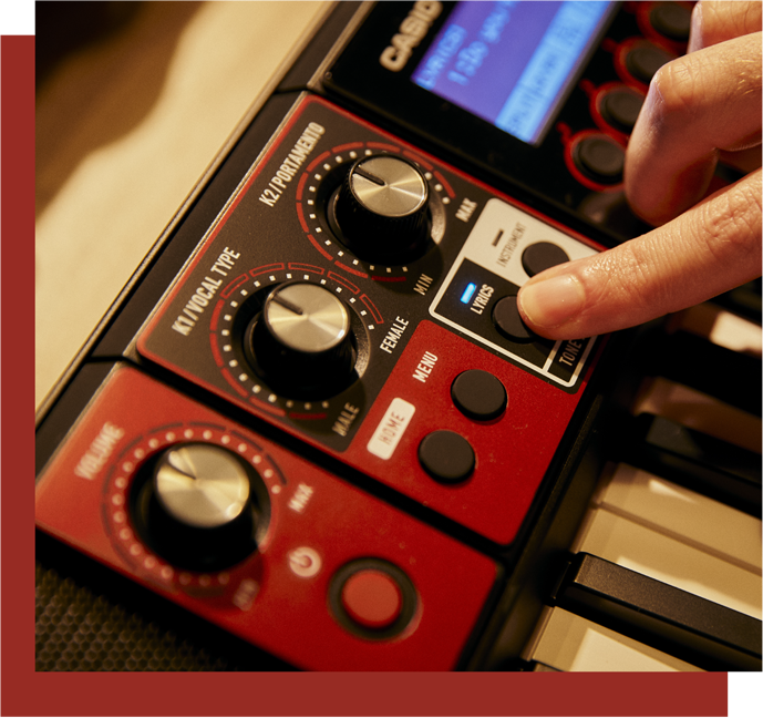 A finger presses the Lyrics button on a CTS1000V