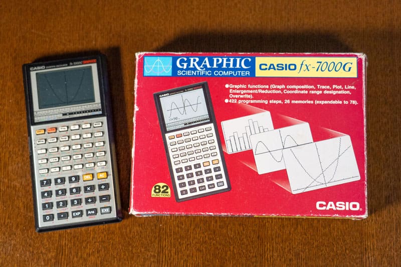 The fx-7000G calculator next to the original packaging in red