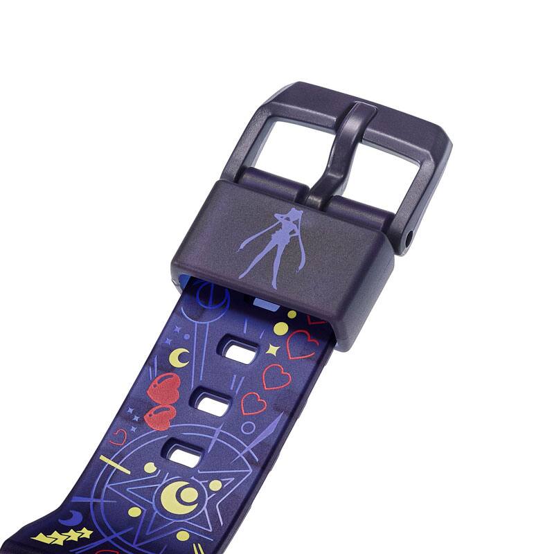 The dark blue strap loop of the BABY-G x Sailor Moon wristwatch with hearts and crescent moons on it