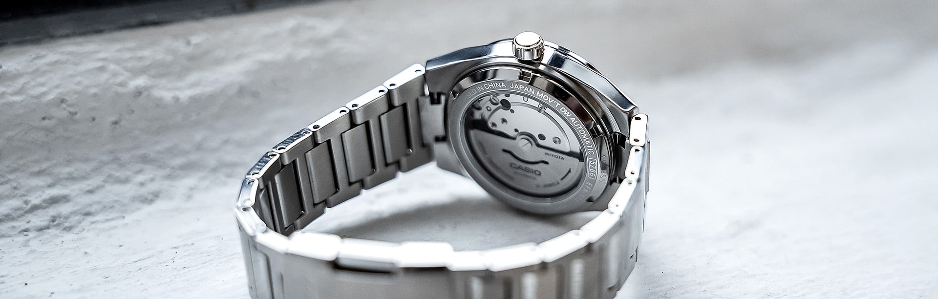 The back of the silver EFK-110 wristwatch with a view of the mechanical watch case.