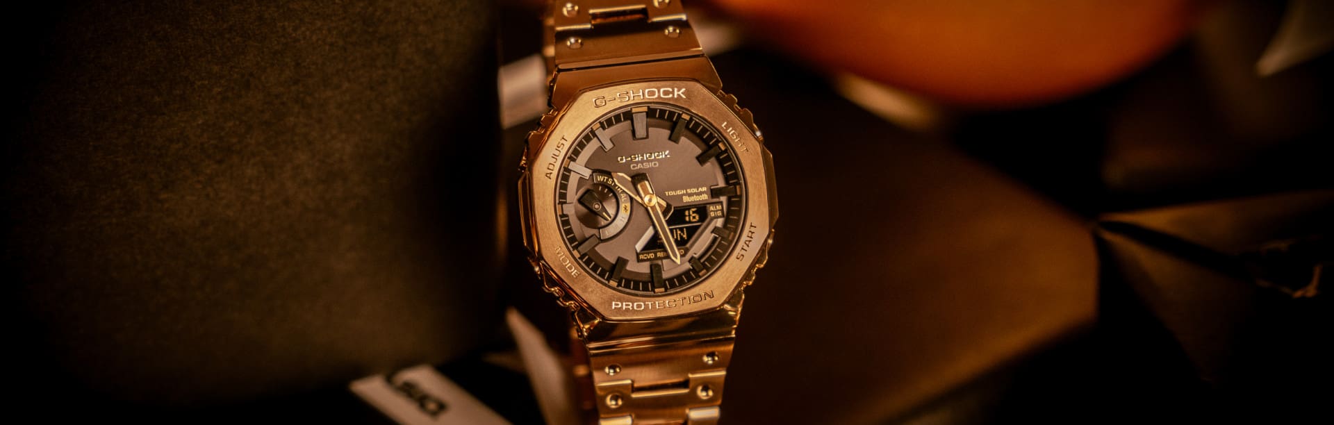 G-SHOCK watch GM-B2100GD-5A on a pile of christmas presents
