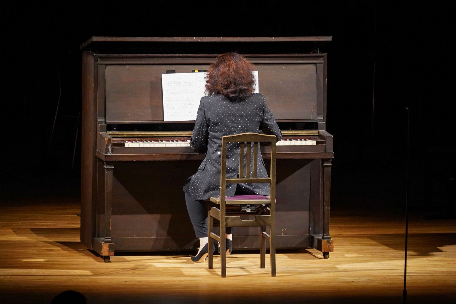 Vue de dos de Martha Argerich jouant du piano Akiko
