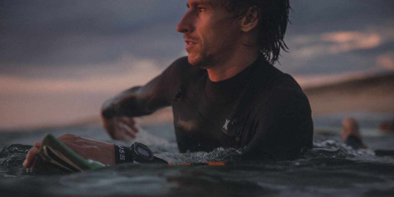 Un surfista in acqua con l'orologio G-Shock G-Lide