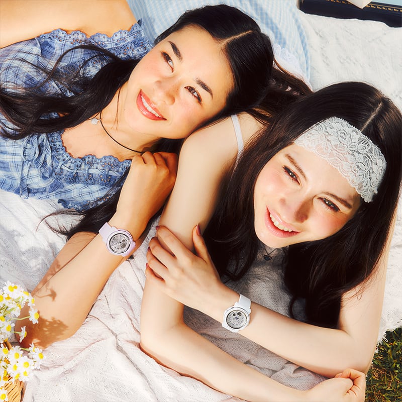 Two women lying down, both wearing BGA-290SA watches