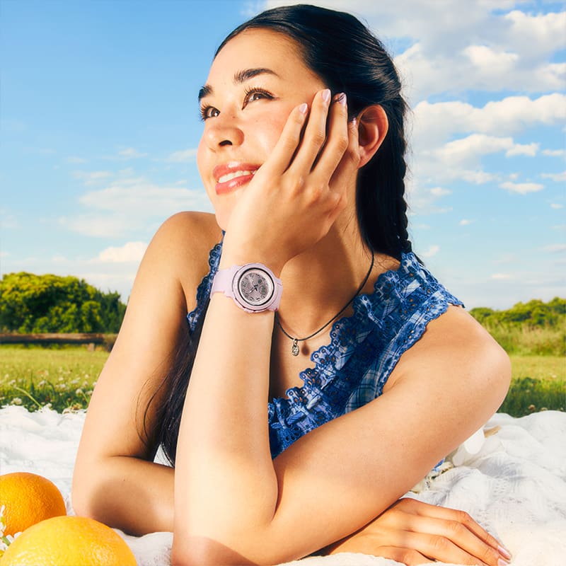 A woman sitting and wearing a BGA-290SA-6A watch