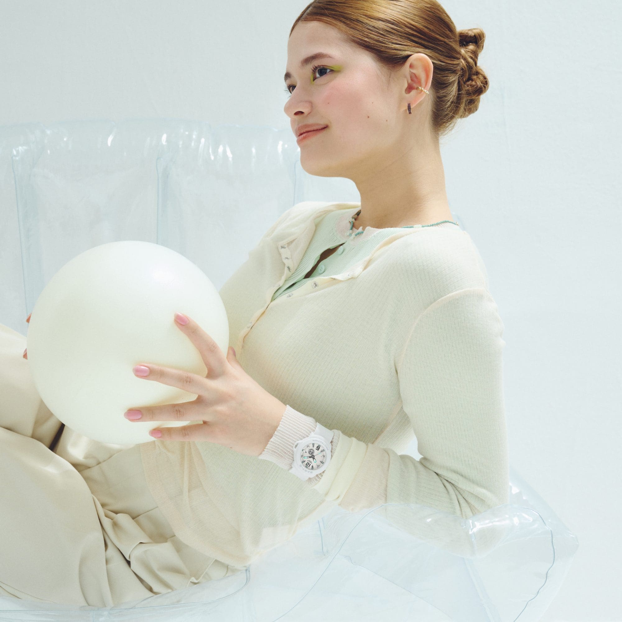 A photo of a woman's upper body wearing a BGA-15K-7A watch on her wrist.