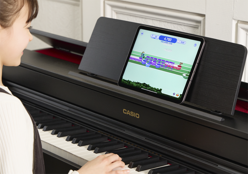 Image of a person playing the piano mini game with the app 