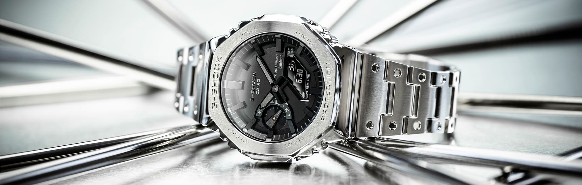 The G-SHOCK GM-B2100 in silver with black dial on mirrored background