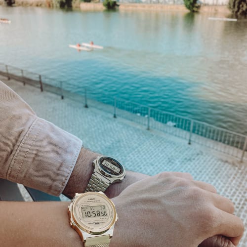 Image of watch being worn: Two hands holding each other with Casio Vintage models A171WEMG-9A and A171-WE1A worn on their arms.