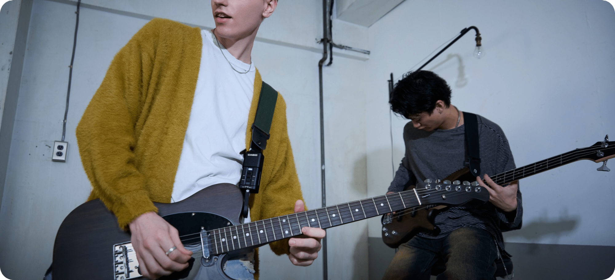 A photo of two male guitarists performing.