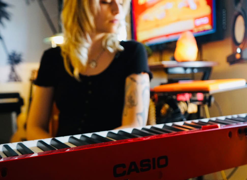 April Rose Gabrielli Behind Piano Slightly Blurred 