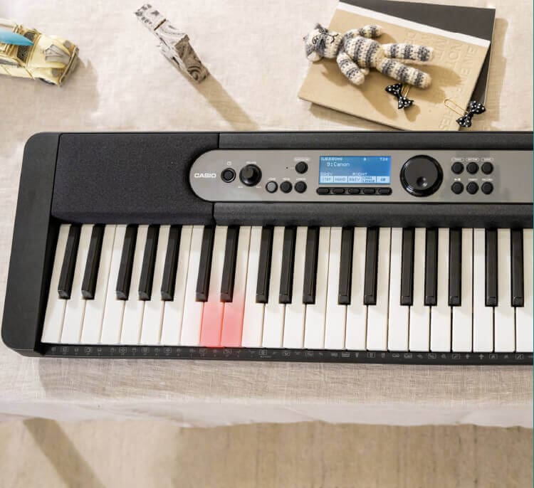 Black Casiotone LK-S450 keyboard displaying lighted keys 