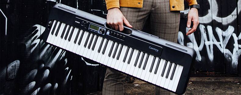 Casiotone CT-S300 keyboard being carried through an urban environment