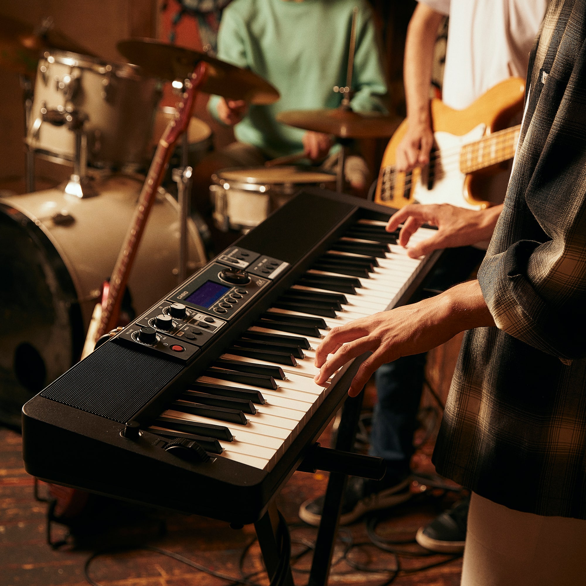 Person playing a Casiotone CT-S500 stage keyboard in a band session.