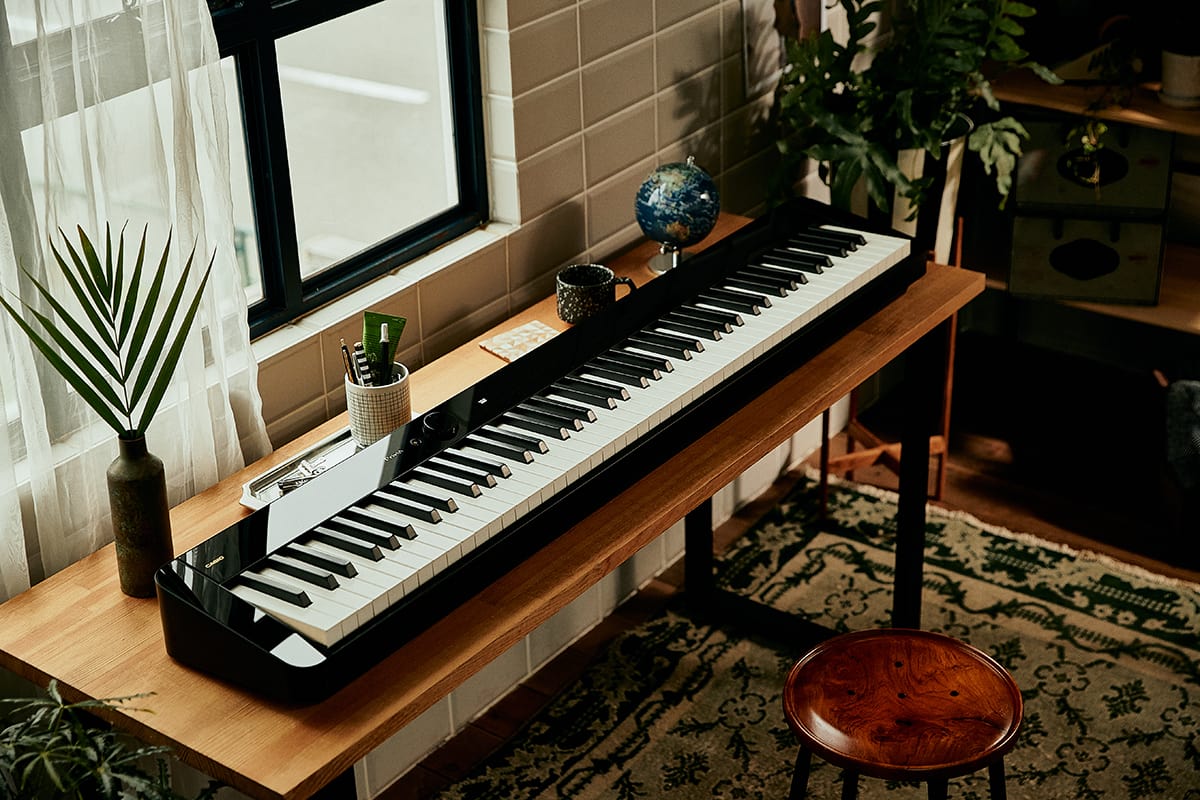 Casio Privia PX-S5000BK 88-key digital piano on a table denoting style.