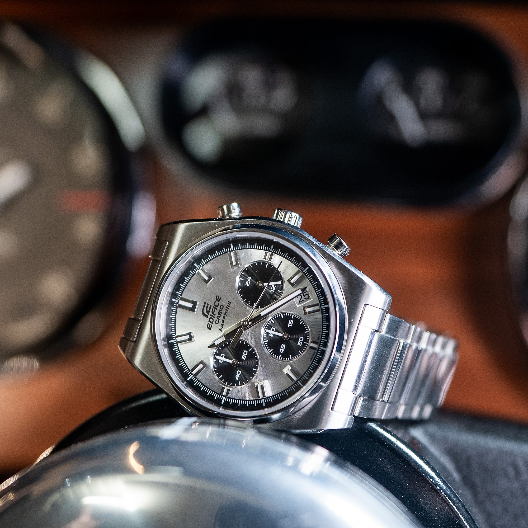 Casio EDIFICE EFB730D-7AV silver watch against a car dashboard denoting chronograph style
