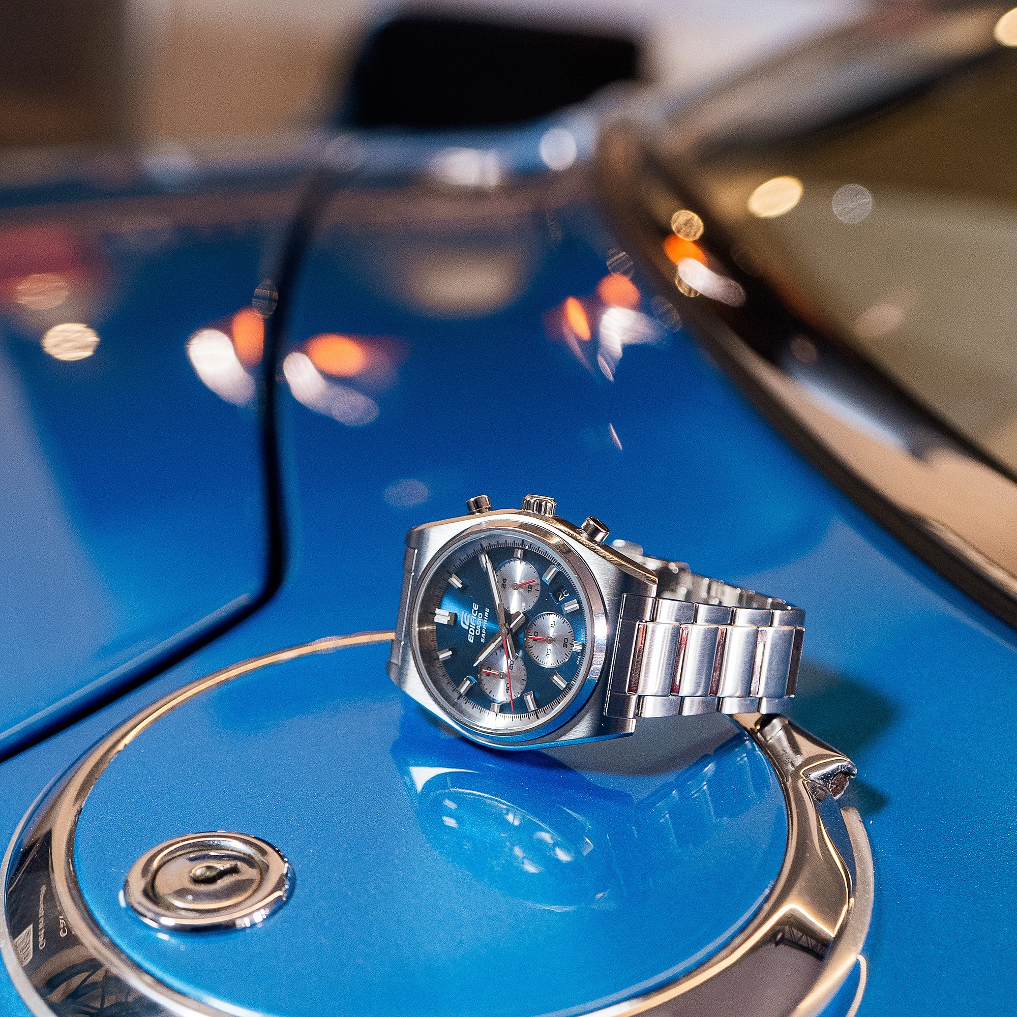 Casio EDIFICE EFB730D-2AV watch on the hood of a car denoting style