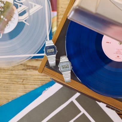 The two models A158WEA-2 and A158WEA-7 are lying on a table with records.