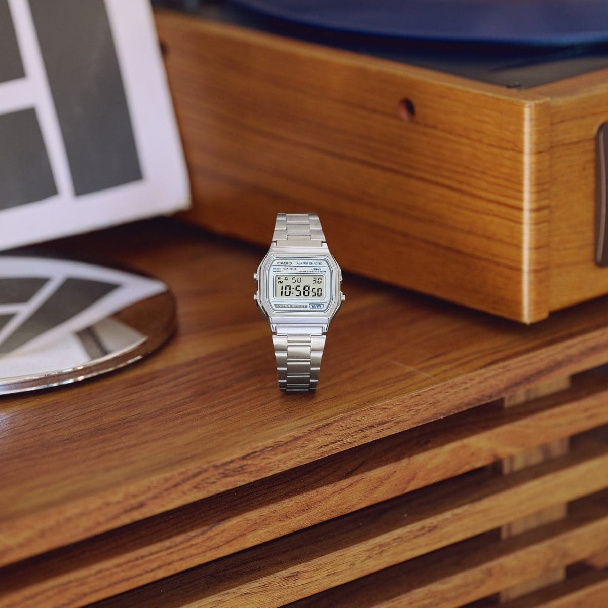 The silver A158WEA-7EF is standing on a wooden shelf.