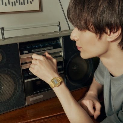 This is a photo of a person adjusting audio equipment while wearing the G-SHOCK A168WG-9.