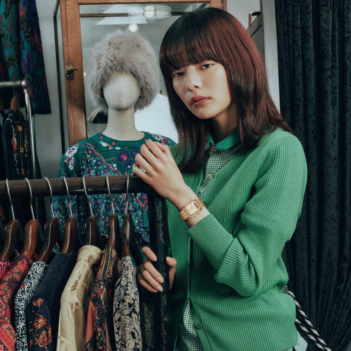 A woman styling an outfit with the G-SHOCK AQ-230GA-9DMQY in a fashion setting.