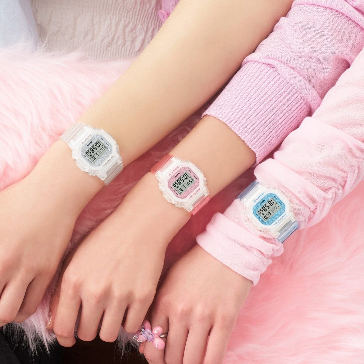 Three color models in this series in white, pink and blue on three wrists each 