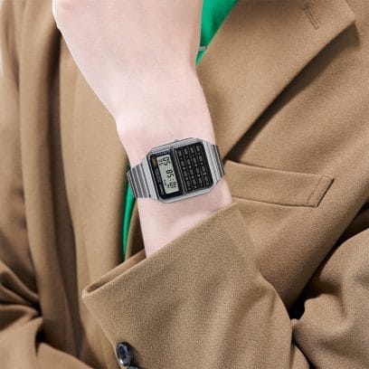 The CA-500WE-1A calculator watch on the wrist of a woman in a light brown blazer