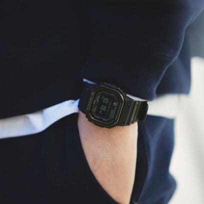 DW-H5600MB-1 On the wrist of a person with their hand in their trouser pocket