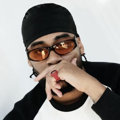 A man with a black cap and sunglasses wears the red DWN-5600-4 little finger