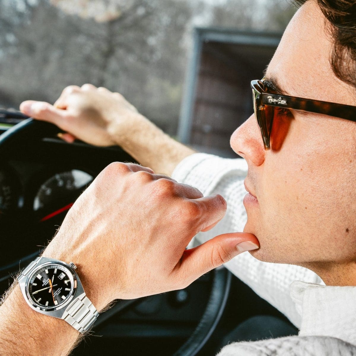 A man sitting in a car wearing the EFB-109D-1AV