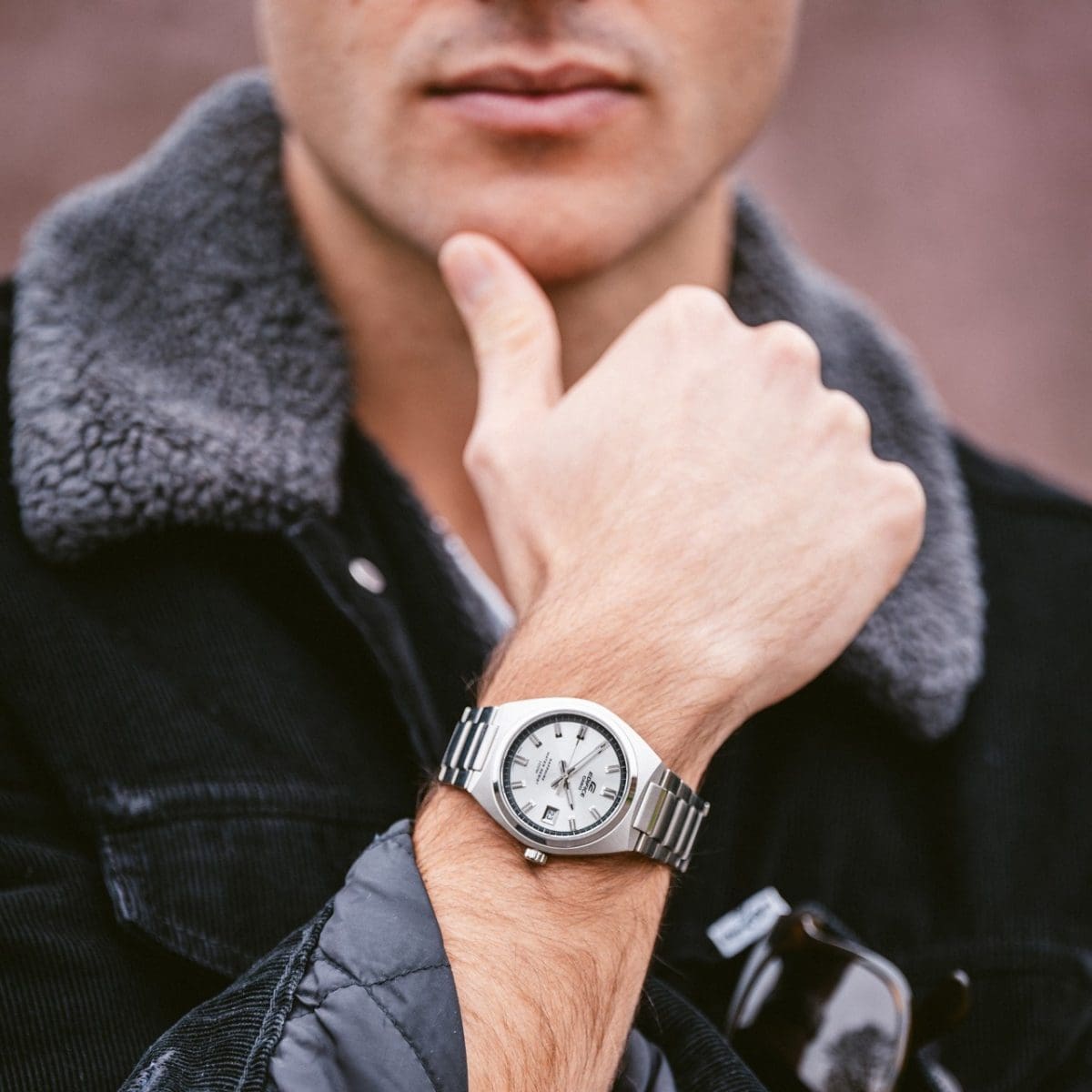 A man is wearing the EFB-109D-7AVEF and is wearing a black jacket with a fur collar