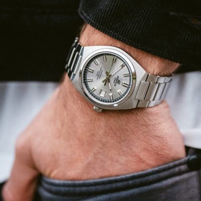 The EFB-109D-7AVEF on the wrist of a man who has put his hand in his trouser pocket