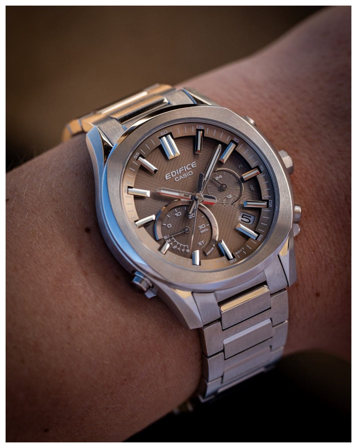 A person is wearing the analog EDIFICE wristwatch EQB-1300D-5AEF on their wrist.