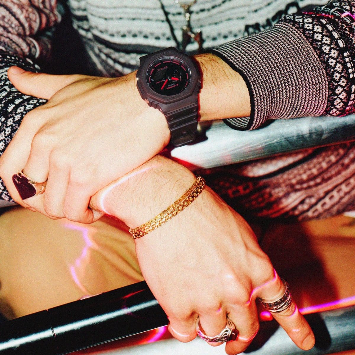 The GA-2100K-5AER on the wrist of a man holding a microphone.
