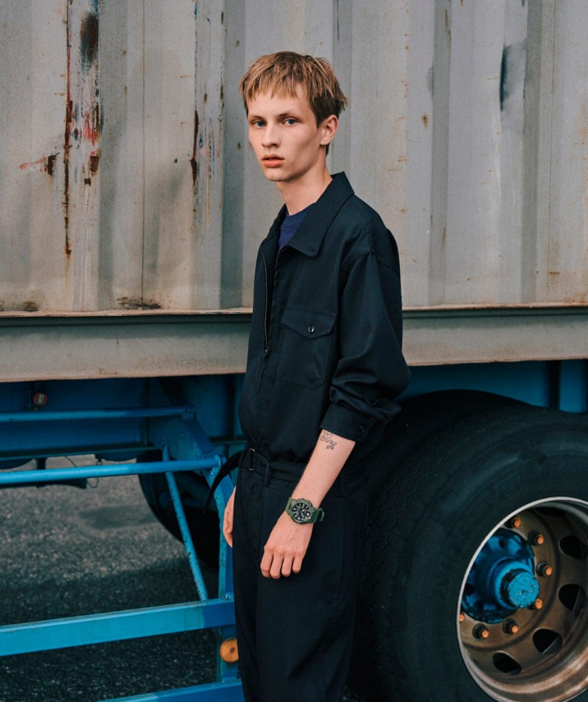 A man wearing a black jumpsuit is wearing the GA-B010-3AER on his wrist.