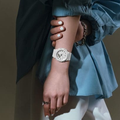 The GMA-P2110-7AER on the wrist of a woman wearing a blue shirt