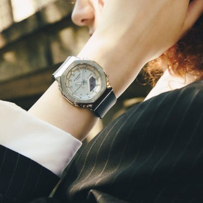 The GM-S2110-1A7ER on the wrist of a woman wearing a black blazer with a white blouse