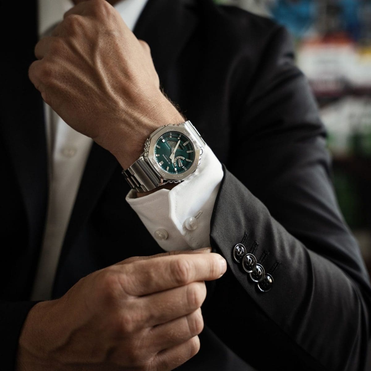 The GM-2110D-3A1ER on the wrist of a man wearing a white shirt and a black jacket
