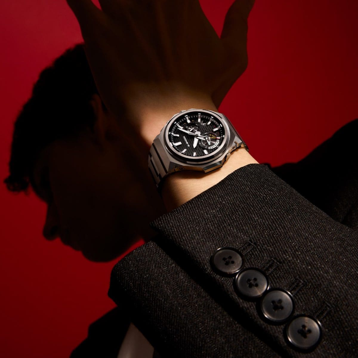 A man wearing a black jacket is wearing the GST-B1000D-1AER on his wrist